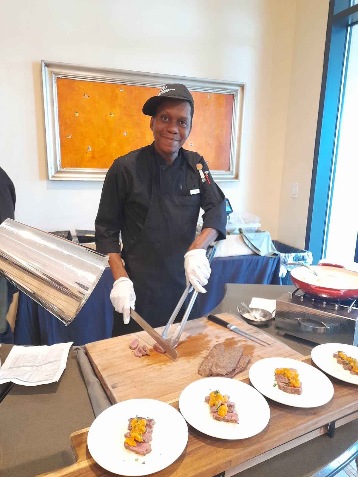 A Polaris participant plating and carving at a US hotel buffet